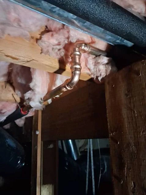 New copper water line with press fittings run along a floor joist